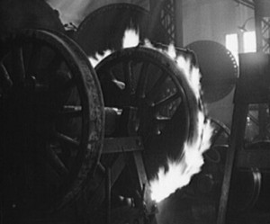 A tire is heated so that it may expand and be fitted to the wheel center. Photo from Atchison, Topeka and Santa Fe shop in Shopton, IA, taken Mar. 1943. Jack Delano photo. Library of Congress collection.