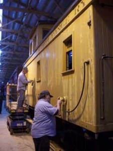 volunteers sanding caboose