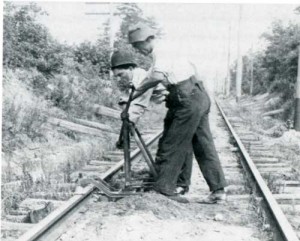 trackmen operating rail drill